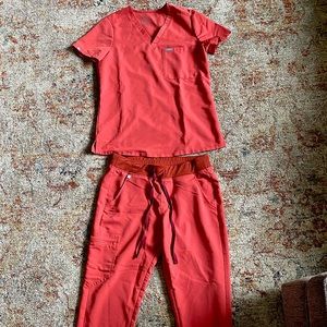 Figs Orange Scrubs with rust colored tie